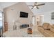 Spacious living room featuring vaulted ceiling, comfortable seating, and a wall-mounted television at 115 Trelawney Cir, Covington, GA 30016