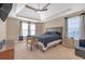Spacious main bedroom with tray ceiling, carpet, and natural light at 115 Trelawney Cir, Covington, GA 30016