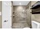 Walk-in shower featuring tiled walls, glass door, and a unique tiled floor pattern at 1406 River Green Nw Dr, Atlanta, GA 30327