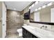 Bathroom with a toilet, shower and vanity with a light up mirror and dark drawers at 1406 River Green Nw Dr, Atlanta, GA 30327