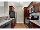 Kitchen with stainless steel appliances, granite countertops, wood cabinets and wood floors at 1406 River Green Nw Dr, Atlanta, GA 30327