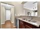 Kitchen with stainless steel dishwasher, sink, granite countertops and wood floors at 1406 River Green Nw Dr, Atlanta, GA 30327