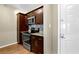 Kitchen area with wood cabinets, granite countertops, microwave, oven and stovetop at 1406 River Green Nw Dr, Atlanta, GA 30327