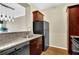 Kitchen area with stainless steel dishwasher, black refrigerator, granite countertops and wood cabinets at 1406 River Green Nw Dr, Atlanta, GA 30327