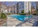 Community swimming pool surrounded by lush landscaping and lounge chairs at 1406 River Green Nw Dr, Atlanta, GA 30327