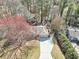 Aerial view features this house, driveway, landscaping, and surrounding trees, offering privacy at 2090 Walden Park, Snellville, GA 30078