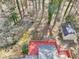 Aerial view of a backyard featuring a spacious wooden deck, outbuilding, and lush greenery at 2090 Walden Park, Snellville, GA 30078