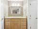 Bathroom featuring a granite countertop, wooden cabinets, and a well-lit mirror for grooming at 2090 Walden Park, Snellville, GA 30078