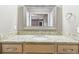 Bathroom with tan vanity and granite countertop, framed mirror, and neutral wall color at 2090 Walden Park, Snellville, GA 30078