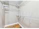 Walk-in closet with custom shelving and hardwood floors at 2090 Walden Park, Snellville, GA 30078