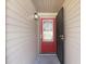 Charming front entryway with a bright red door and secure metal storm door at 2090 Walden Park, Snellville, GA 30078