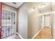 Hallway with hardwood floors and freshly painted grey walls with storm door open at 2090 Walden Park, Snellville, GA 30078