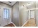 Hallway with freshly painted grey walls, hardwood floors, and a door with decorative glass at 2090 Walden Park, Snellville, GA 30078