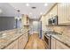 Modern kitchen featuring stainless steel appliances, granite countertops, and hardwood floors at 2090 Walden Park, Snellville, GA 30078
