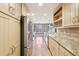Gourmet kitchen featuring stainless steel appliances, long countertops, and open shelving at 2090 Walden Park, Snellville, GA 30078
