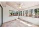 The sunroom has neutral walls, a tile floor and windows looking out to the backyard at 2090 Walden Park, Snellville, GA 30078
