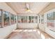 The sunroom has neutral walls, a tile floor and windows looking out to the backyard at 2090 Walden Park, Snellville, GA 30078