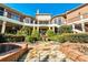 Multi-tiered outdoor living space with fountain, balconies, and beautiful landscaping at 3832 Wesley Chapel Rd, Marietta, GA 30062