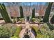 Aerial view of professionally landscaped yard with hedges, stone paths and a fountain at 3832 Wesley Chapel Rd, Marietta, GA 30062