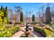 Professionally landscaped grounds with stone paths, water feature, and manicured hedges at 3832 Wesley Chapel Rd, Marietta, GA 30062