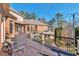 Spacious deck and patio with wrought iron railing and view of the professionally landscaped yard at 3832 Wesley Chapel Rd, Marietta, GA 30062