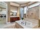 Luxurious bathroom featuring a soaking tub, tiled floors, and a double vanity at 3832 Wesley Chapel Rd, Marietta, GA 30062