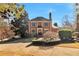 Elegant brick home boasts a classic design with a manicured front yard and a welcoming driveway at 3832 Wesley Chapel Rd, Marietta, GA 30062