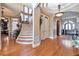 Elegant foyer featuring a curved staircase, hardwood floors, and a decorative tray ceiling with chandelier at 3832 Wesley Chapel Rd, Marietta, GA 30062