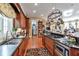 Chef's kitchen showcasing granite counters, stainless steel appliances, and pot rack over gas cooktop at 3832 Wesley Chapel Rd, Marietta, GA 30062