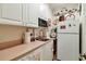 Charming kitchenette with white cabinets, modern appliances, and collegiate-themed decor at 3832 Wesley Chapel Rd, Marietta, GA 30062