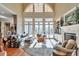 Sun-filled living room with a fireplace, hardwood floors, and floor to ceiling windows at 3832 Wesley Chapel Rd, Marietta, GA 30062