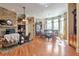 Open-concept living area with stone fireplace, hardwood floors, and adjacent dining area with large windows at 3832 Wesley Chapel Rd, Marietta, GA 30062
