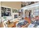 Bright living room with fireplace, built-in bookshelves, and hardwood floors beneath a soaring two-story ceiling at 3832 Wesley Chapel Rd, Marietta, GA 30062
