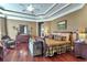 Spacious main bedroom with hardwood floors, a tray ceiling, and a cozy sitting area at 3832 Wesley Chapel Rd, Marietta, GA 30062