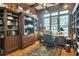 Wood-paneled office featuring custom shelving, a large window, and hardwood floors at 3832 Wesley Chapel Rd, Marietta, GA 30062