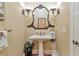 Charming powder room with pedestal sink, decorative mirror, and classic fixtures at 3832 Wesley Chapel Rd, Marietta, GA 30062