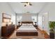 Staged primary bedroom featuring a large bed and a ceiling fan at 4550 Cold Spring Ct, Cumming, GA 30041