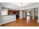 Open concept kitchen with breakfast bar, stainless appliances, and hardwood flooring at 4550 Cold Spring Ct, Cumming, GA 30041