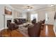 Cozy staged living room with fireplace, stylish furniture, and hardwood flooring at 4550 Cold Spring Ct, Cumming, GA 30041