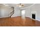 Inviting living room with hardwood floors, fireplace, and staircase access at 4550 Cold Spring Ct, Cumming, GA 30041