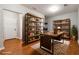 Cozy office space with custom wooden bookshelves and a modern desk setup at 4550 Cold Spring Ct, Cumming, GA 30041