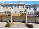 Rear view of townhomes with garage parking and private back decks on each unit at 4550 Cold Spring Ct, Cumming, GA 30041