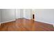 Spacious room featuring hardwood floors, and three entryways into other rooms of the home at 4550 Cold Spring Ct, Cumming, GA 30041
