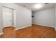 Spacious room featuring hardwood floors, and an entryway into another room of the home at 4550 Cold Spring Ct, Cumming, GA 30041