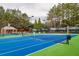 Well-lit tennis court with a vibrant blue surface and professional-grade nets at 4550 Cold Spring Ct, Cumming, GA 30041