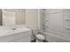 Clean bathroom with white cabinets, a large mirror and a white tub with shower combo at 1069 Blue Juniper Cir, Loganville, GA 30052