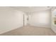 The spacious bedroom has neutral carpeting, white walls, and a bright window at 1069 Blue Juniper Cir, Loganville, GA 30052
