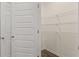 Bright walk-in closet featuring white wire shelving and a neutral wall color at 1069 Blue Juniper Cir, Loganville, GA 30052