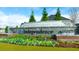 Community entrance sign with water feature surrounded by colorful flowers at 1069 Blue Juniper Cir, Loganville, GA 30052
