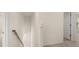 Bright hallway with a staircase and view into a room with natural light at 1069 Blue Juniper Cir, Loganville, GA 30052
